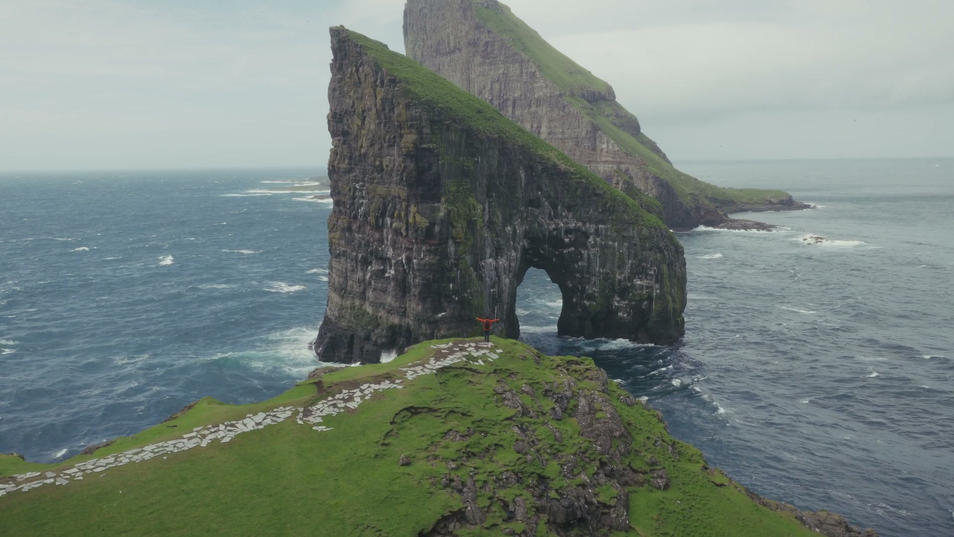A sea arch rising from the coast of the Faroe Islands